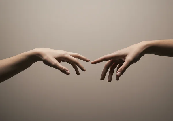 Hands reaching but one pulls away, symbolizing rejection