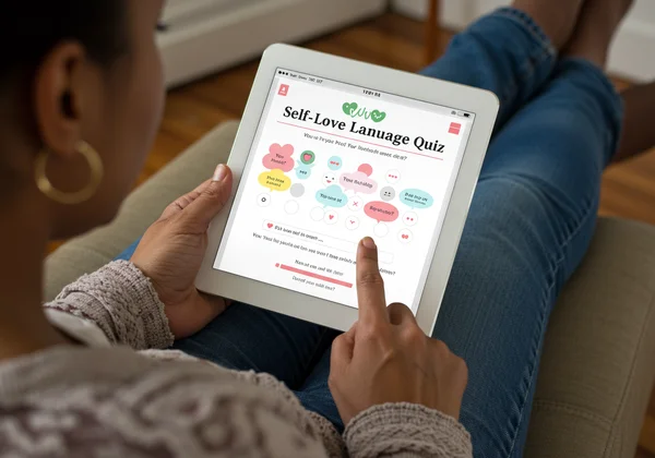 Person taking a self-love language quiz on a tablet
